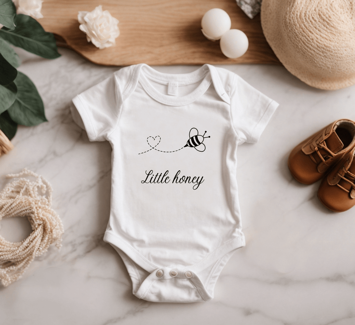 Laat je baby stralen in dit schattige rompertje met de opdruk 'little honey'